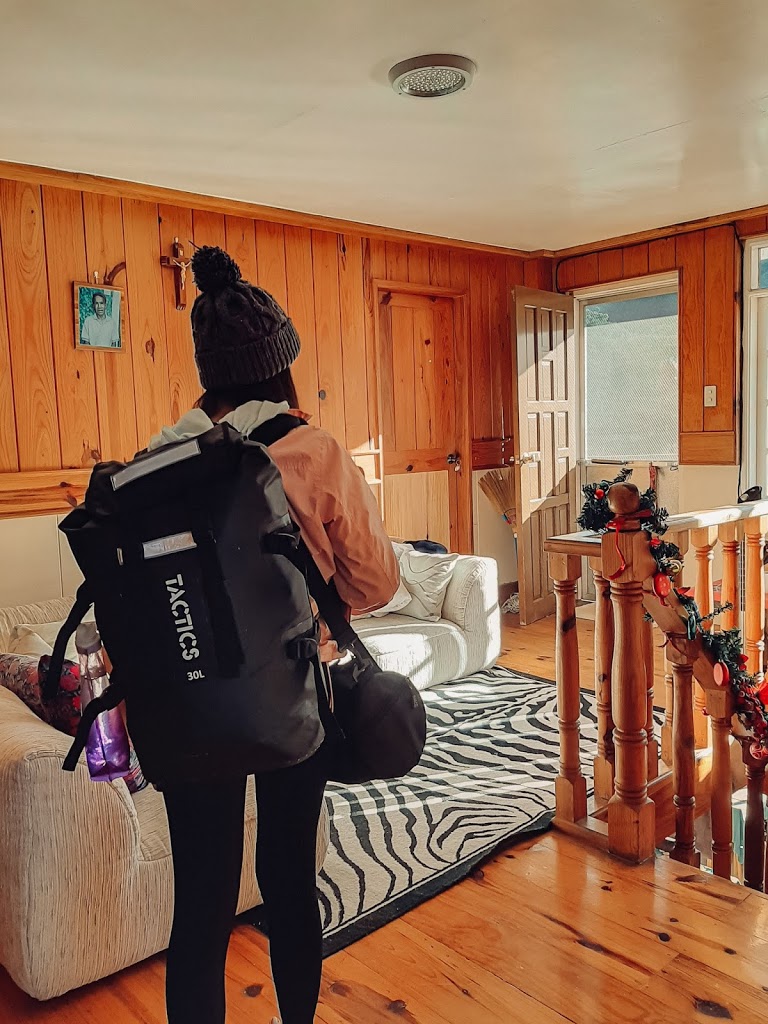 a lady on its back with a black backpack in a living room