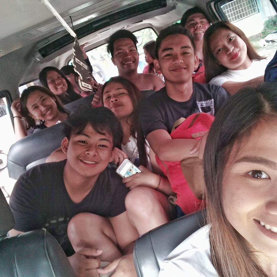 a selfie of a group of boys and girls inside a van