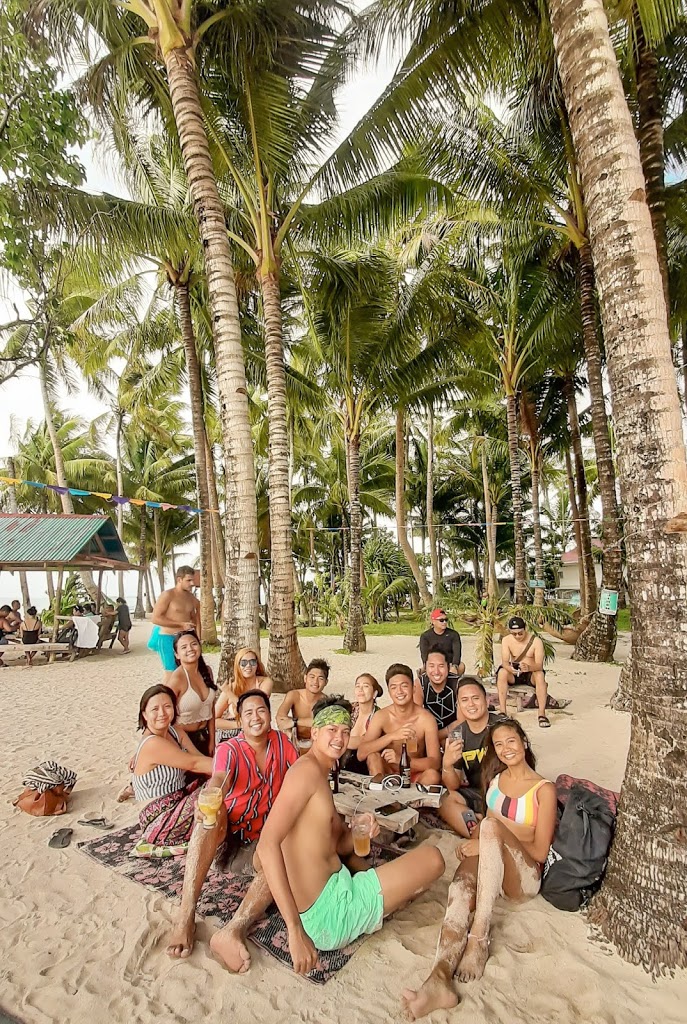 a group of friends at a beach in Siargao